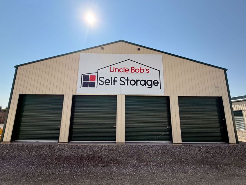 Uncle Bob's Self Storage sign on a facility building with 4 units below