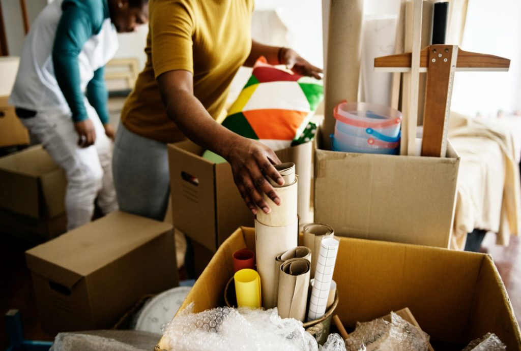 Couple storing their possessions on boxes
