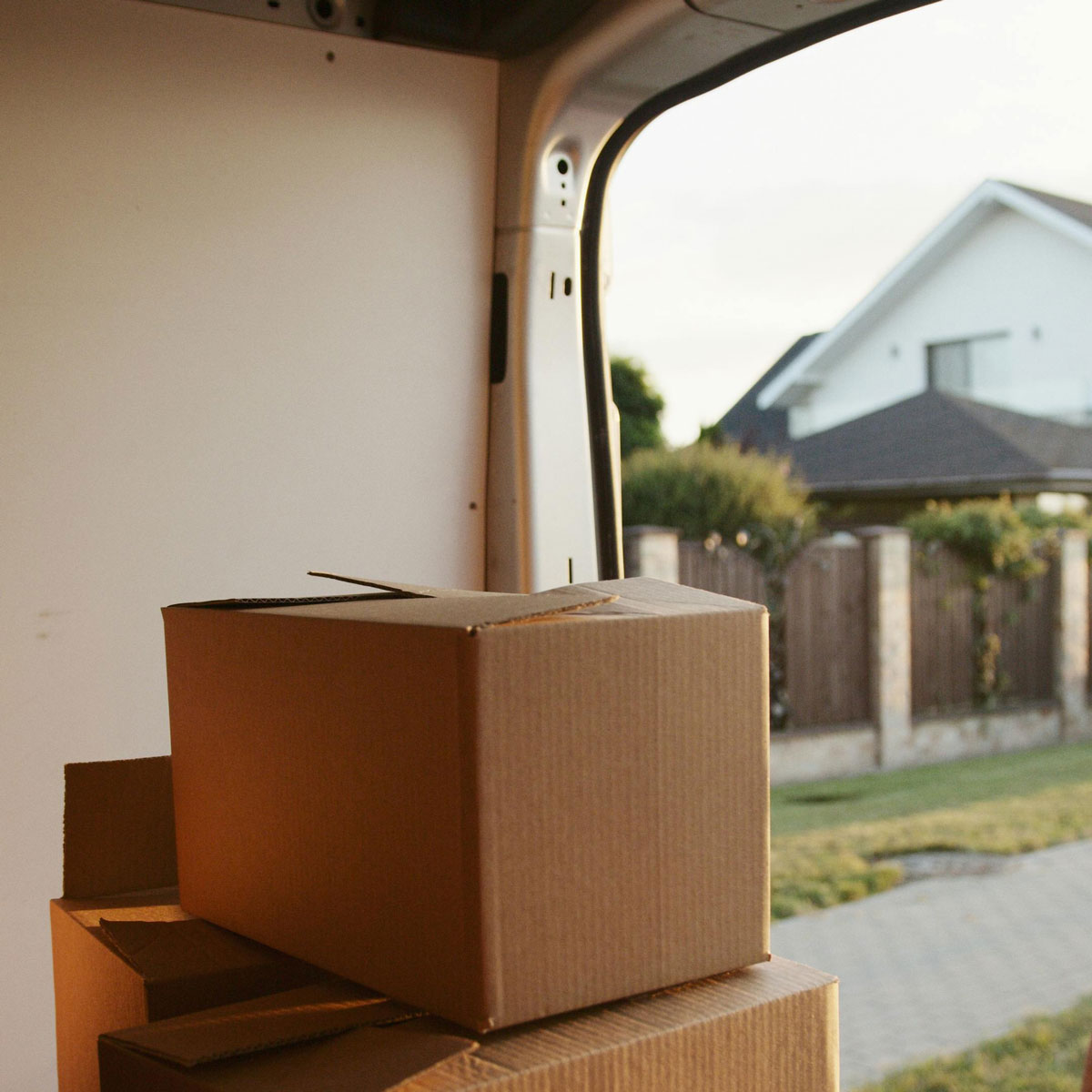 Cardboard boxes stacked for moving into a self storage facility, highlighting affordable storage cost in Okotoks.